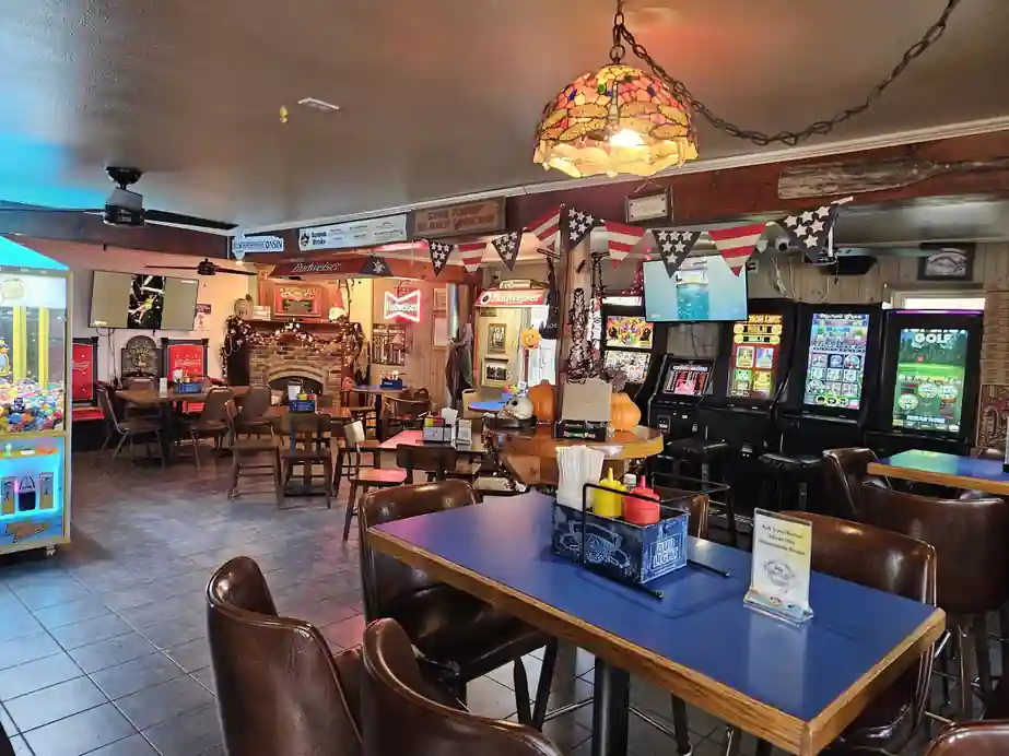 Pioneer dining room with a Tiffany lamp over the tables and arcade machines along the wall
