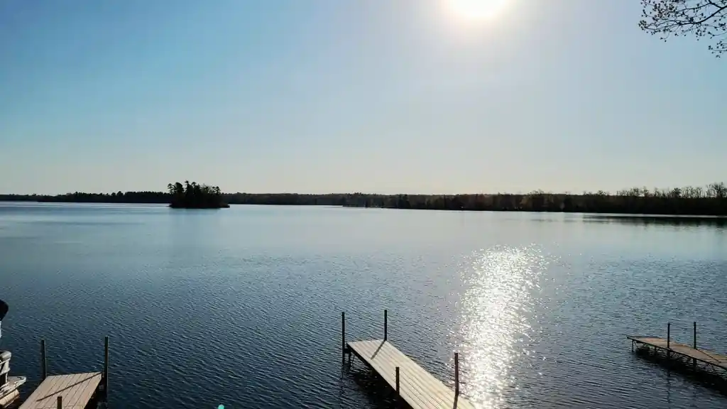 Long Lake from the Pioneer docks with a small island and the sun on the water